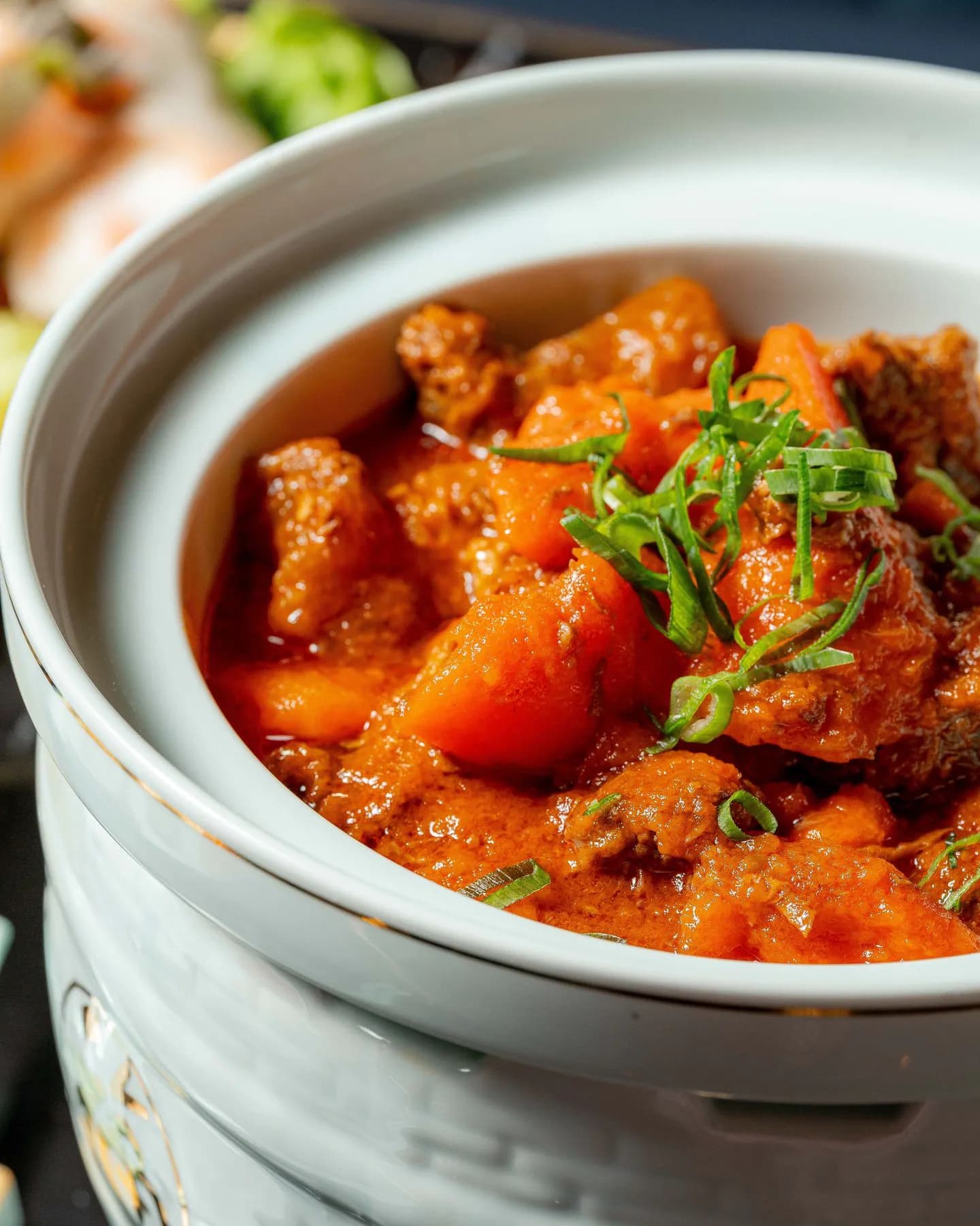 Chinese ceramic hot pot with beef stew and vegetables